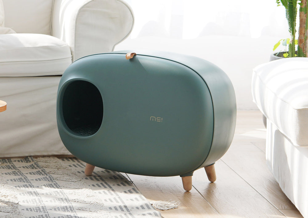 Groene design kattenbak in een lichte woonkamer