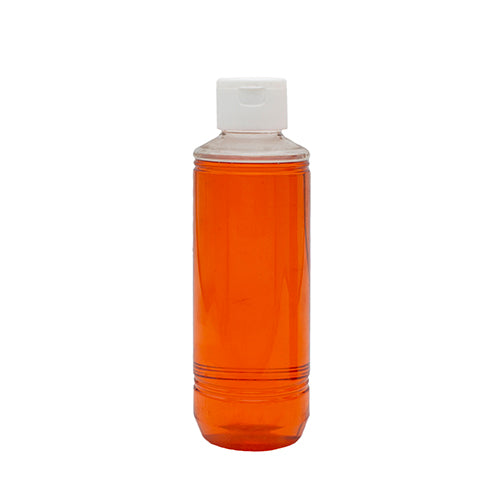 Doorzichtige fles met oranje zalmolie